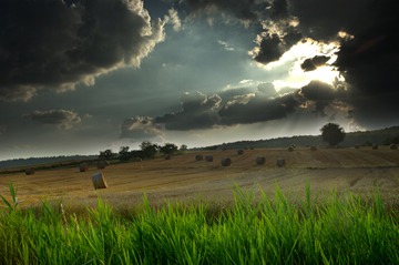 dark clouds over a field with hay bales, Keltern, Baden-Wrttemberg, Germany