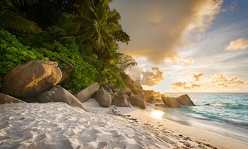 tropical beach with rocks at sunset, Maldives